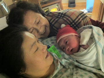 Grandma Mrs. Choi and mom Stella Choi Lin look lovingly at Isabelle, the beautiful and welcome addition to their family and perhaps the future star of ... - oc_13